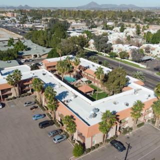 Aerial view of a building complex with a central courtyard and surrounding urban landscape.