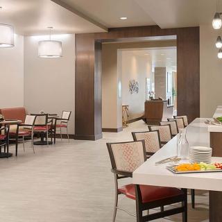 A modern dining area with neatly arranged seating and stylish lighting.