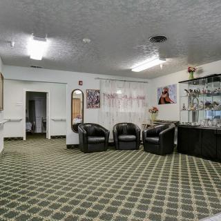 A modern lobby with comfortable seating and a bar counter.