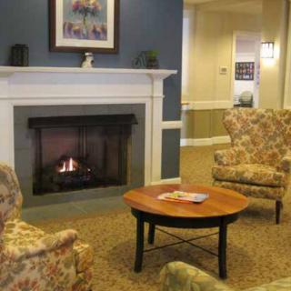 A cozy living room with a fireplace and comfortable seating.