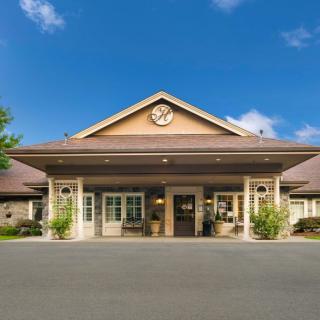 A welcoming building with a covered entrance and symmetrical design.