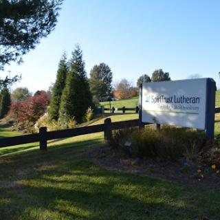 A welcoming entrance sign surrounded by well-maintained greenery.