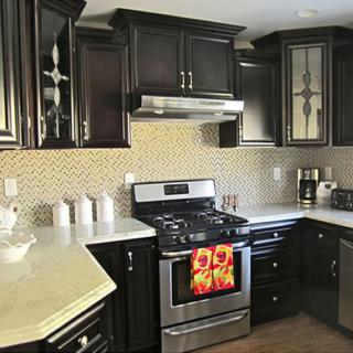 A modern kitchen with dark cabinets and stainless steel appliances.