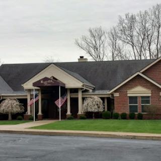 A welcoming community building with flags, set against a gray sky.