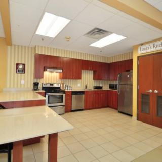 A modern kitchen with wooden cabinets and stainless steel appliances.