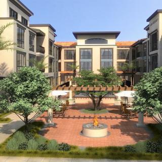 A modern residential complex with a landscaped courtyard and trees.