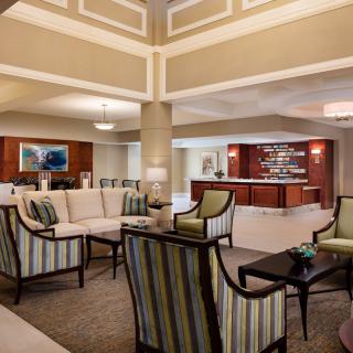 A modern hotel lobby with elegant seating and a reception desk.