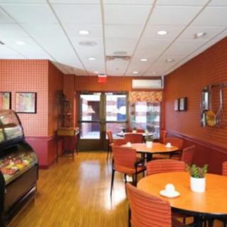 A cozy cafe interior with tables and chairs arranged for dining.