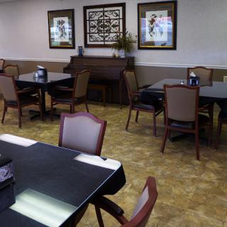 A spacious dining area featuring tables and chairs, with decorative elements on the walls.