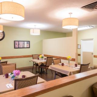 A cozy dining area with neatly arranged tables and soft lighting, perfect for meals.