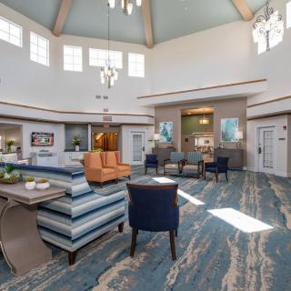 A spacious and well-lit lobby featuring modern furniture and decor.