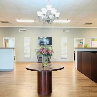 A modern and inviting lobby with elegant decor and floral arrangements.