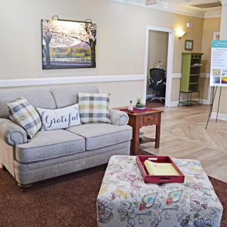 A cozy living room with a comfortable sofa, cushions, and a decorative coffee table.
