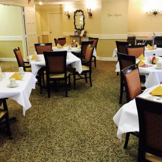 A neatly arranged dining area with tables set for guests.