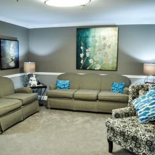 A modern living room with stylish furniture and art decor.