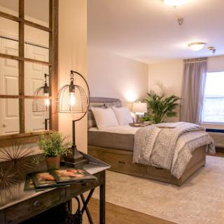 A beautifully designed modern bedroom featuring a comfortable bed, stylish furniture, and soft lighting.