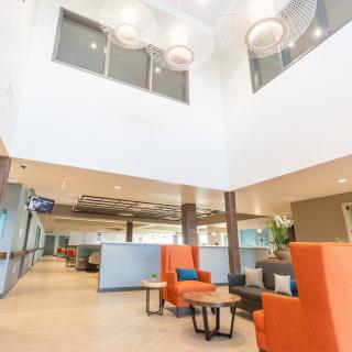 A modern office lobby with vibrant seating and ample natural light.