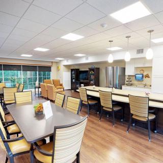 A spacious and modern kitchen with a dining area featuring ample seating and bright lighting.