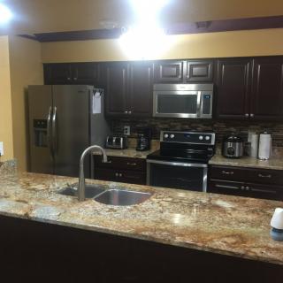 Modern kitchen with stainless steel appliances and granite countertop.
