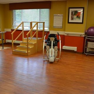 A physical therapy and rehabilitation room featuring exercise equipment and training stairs.