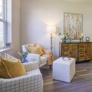 A cozy living room with modern decor, featuring comfortable seating and warm lighting.