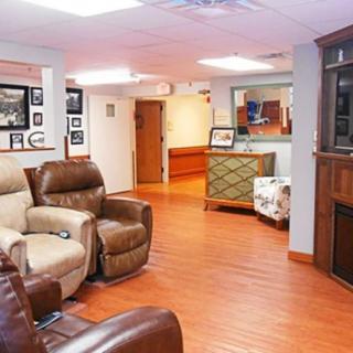 A cozy living room with recliner chairs and wood flooring.