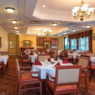 A well-arranged dining room in a restaurant with elegantly set tables and comfortable seating.
