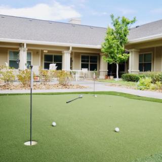A well-maintained putting green in a courtyard setting.