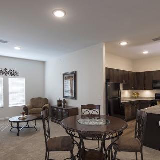 An open-concept living space combining a dining area and kitchen with modern decor.