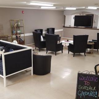 A cozy lounge area with comfortable seating and a television welcoming guests.