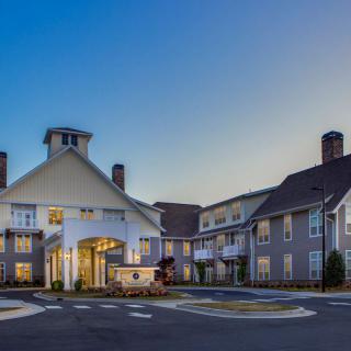 A modern hotel building with a welcoming entrance during the evening.