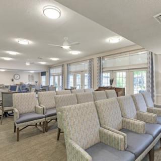 A bright and modern waiting area with comfortable seating and large windows.