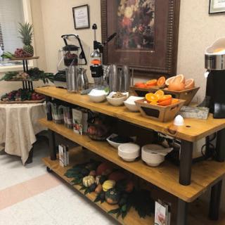 A cozy breakfast bar setup featuring a variety of fresh fruits and beverage options.