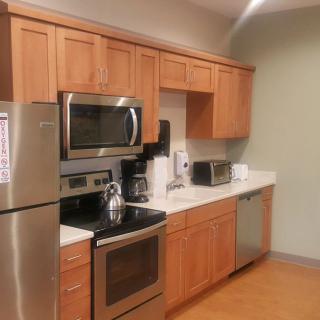 Modern kitchen with stainless steel appliances and wooden cabinets.