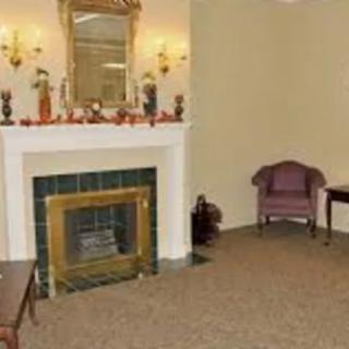 A cozy living room with a fireplace and traditional decor.