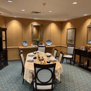 An elegantly set dining room table with a formal and sophisticated ambiance.