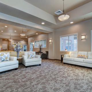 A modern and cozy living room featuring white sofas and soft lighting.