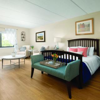 A modern and cozy bedroom with stylish furniture and decor.