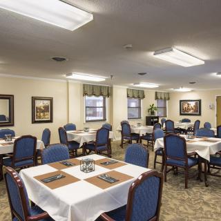 An elegant dining room with neatly arranged tables and chairs.