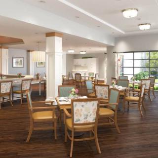 A spacious and well-lit dining area with wooden tables and chairs, featuring elegant decor and a warm ambiance.