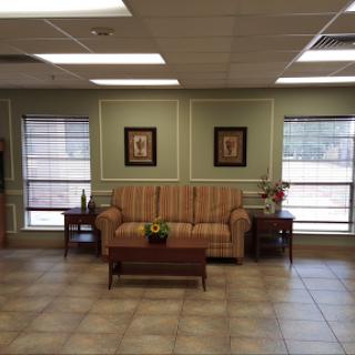 A cozy waiting area featuring a comfortable sofa and decorative artwork.