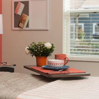 A cozy breakfast setup featuring a floral centerpiece and colorful tableware.