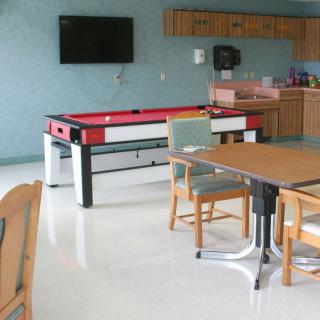 A game room featuring a pool table, television, and seating area.