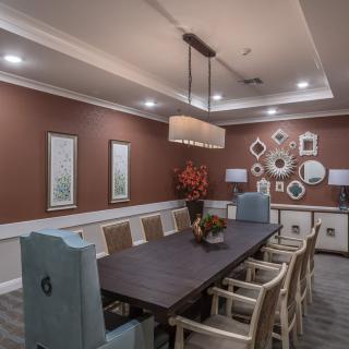 A modern dining room with elegant decor and ambient lighting.