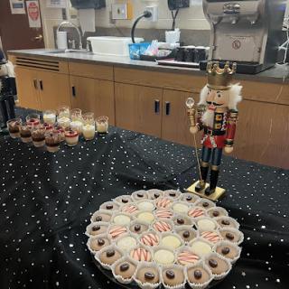 A festive display featuring a nutcracker and an assortment of holiday cookies and desserts.
