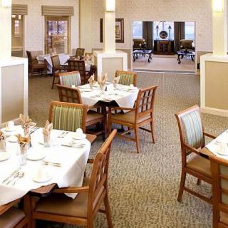 An elegant dining room setup with neatly arranged tables and chairs.