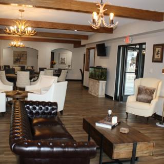 A cozy lounge area with comfortable seating, elegant chandeliers, and modern decor.