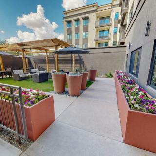 A modern outdoor patio with planters and seating in an urban setting.