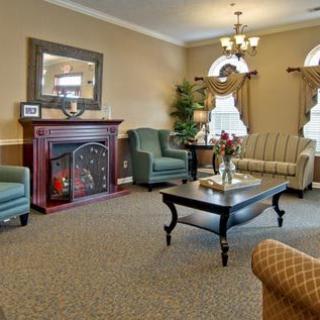 A cozy living room with elegant furniture and a warm fireplace.