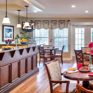 A stylish dining area with a bar, elegant furnishings, and contemporary decor.